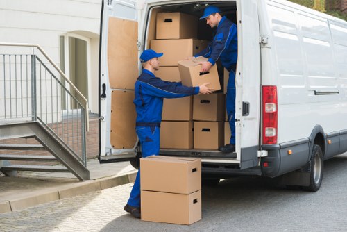 Removal team handling same day removals in Richmond with packed moving boxes