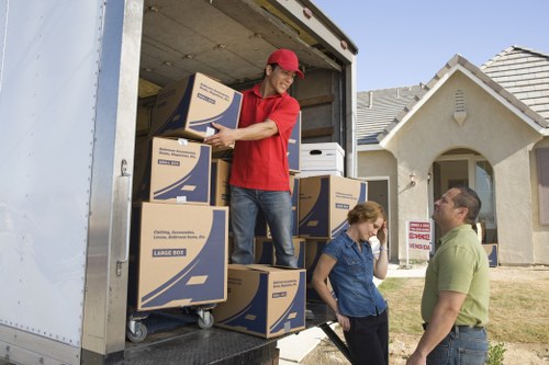 Moving team navigating a Richmond neighborhood with a van