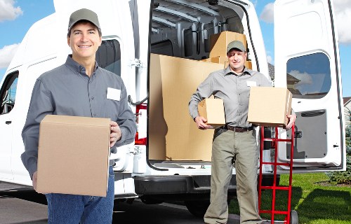 Removal worker carrying a box carefully during a house move